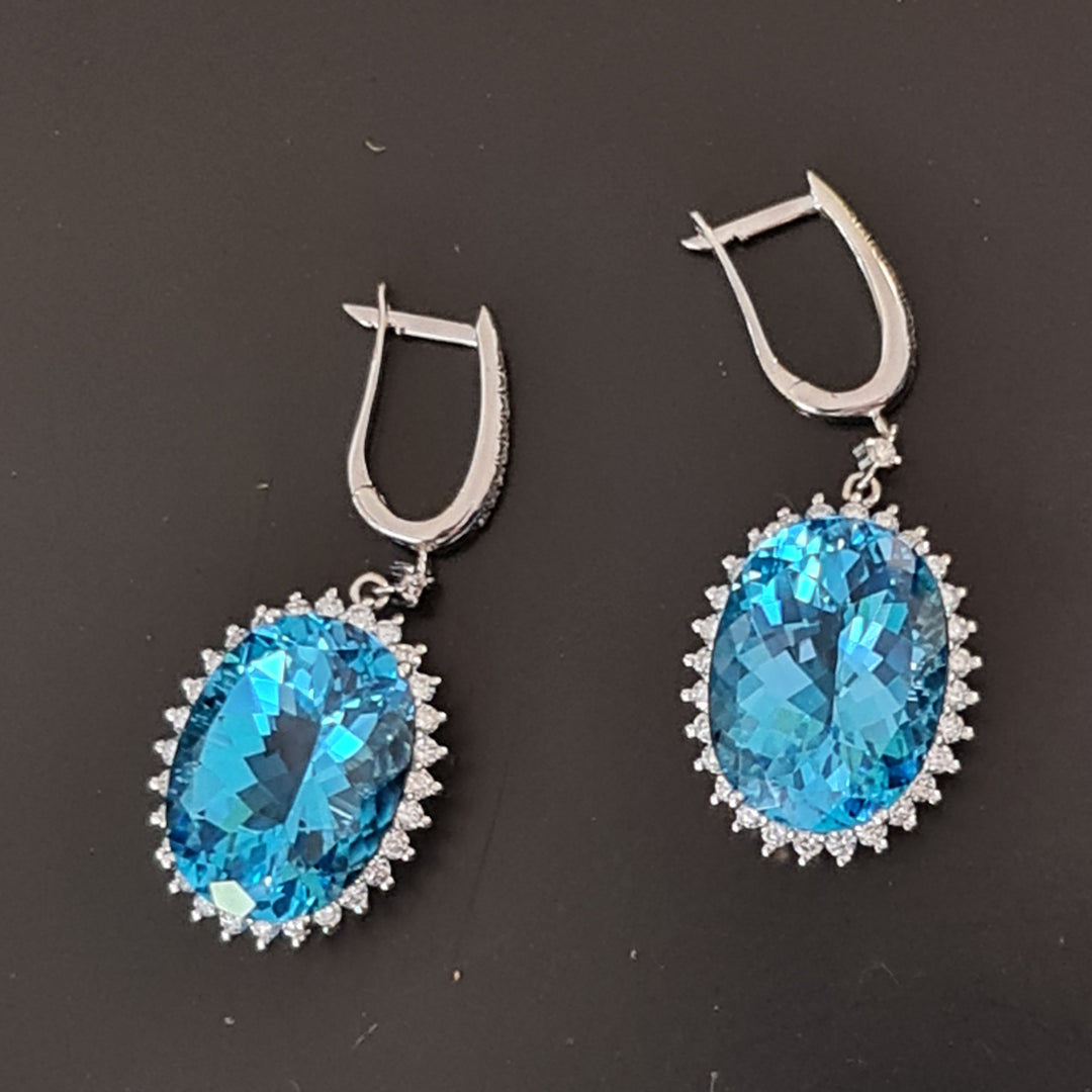 Neta - 21.00 carat oval natural blue topaz earrings with 2.50 carat natural diamonds